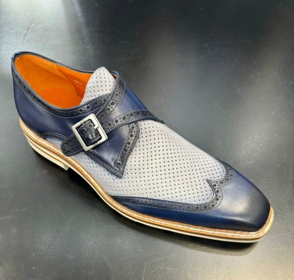 A pair of blue and white shoes with a buckle on the side