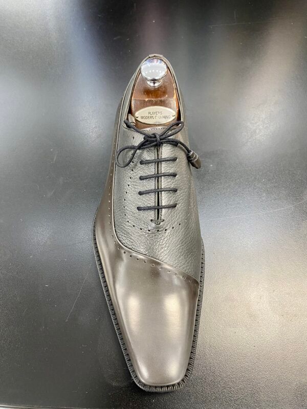 A close up of a pair of shoes on a table.