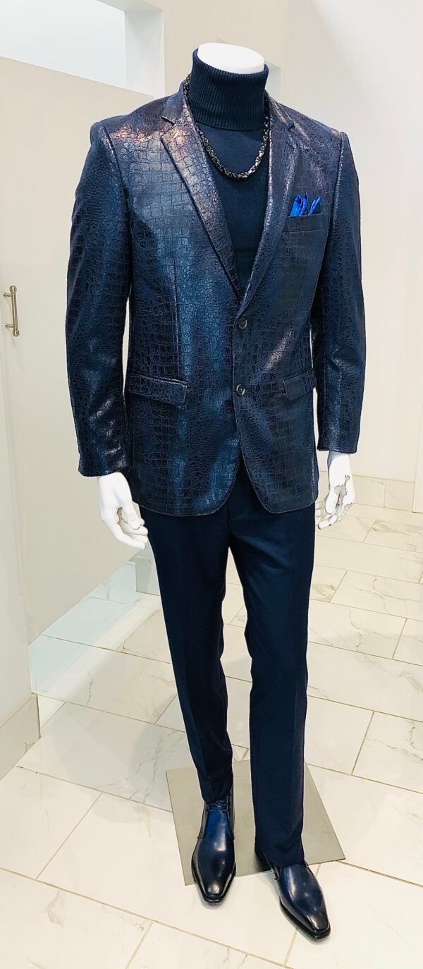 A mannequin is wearing a blue suit jacket and black turtleneck.