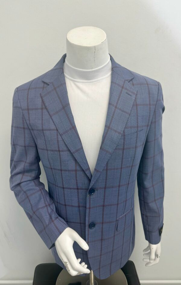 A mannequin wearing a blue plaid jacket and a white turtleneck