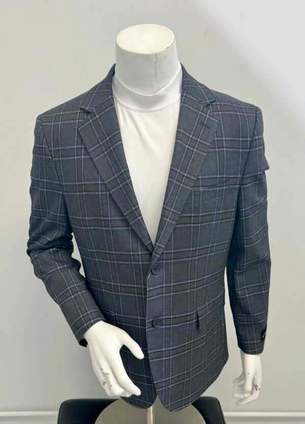 A mannequin is wearing a plaid jacket and a white turtleneck.