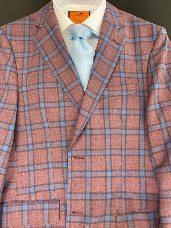 A close up of a plaid suit jacket and tie
