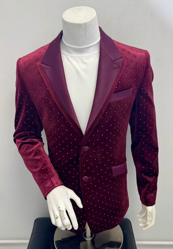 A mannequin is wearing a maroon jacket with white polka dots