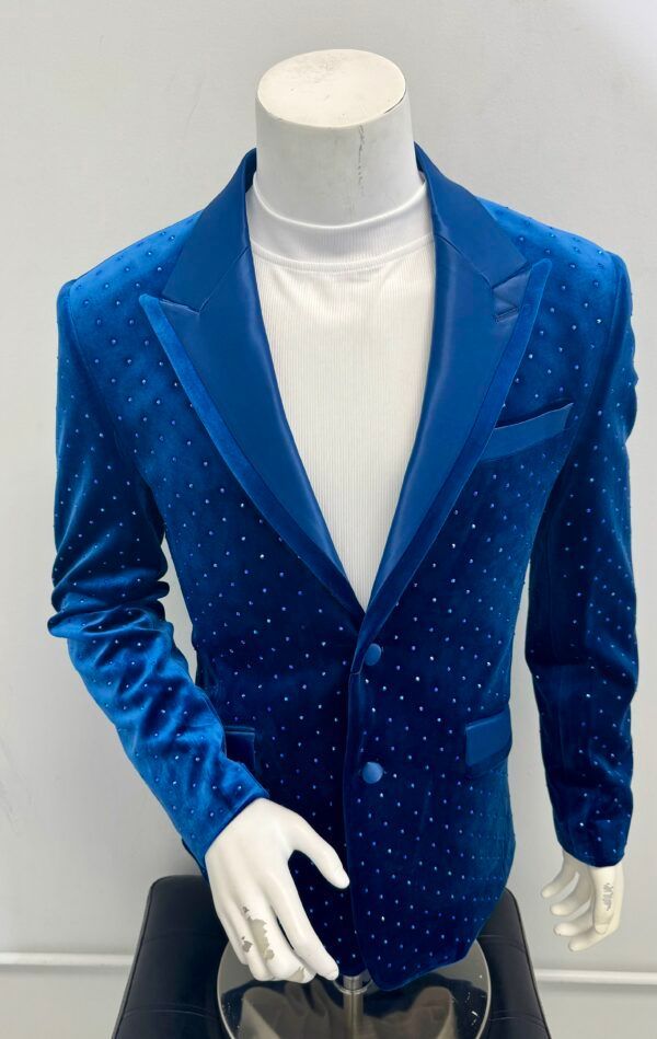 A blue velvet jacket with rhinestones on the sleeves is on a mannequin
