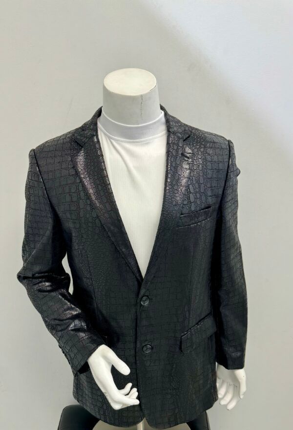 A mannequin is wearing a black jacket and a white turtleneck.