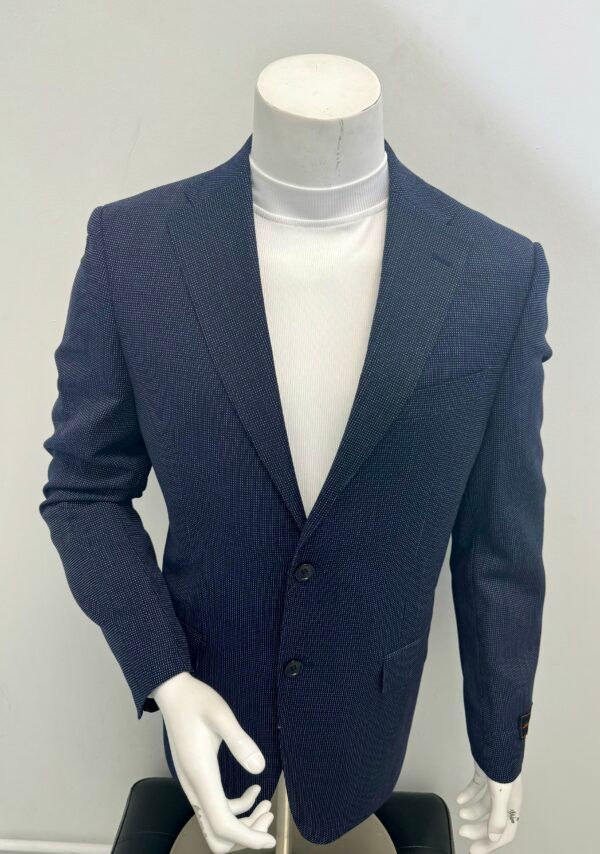 A mannequin wearing a blue jacket and white turtleneck