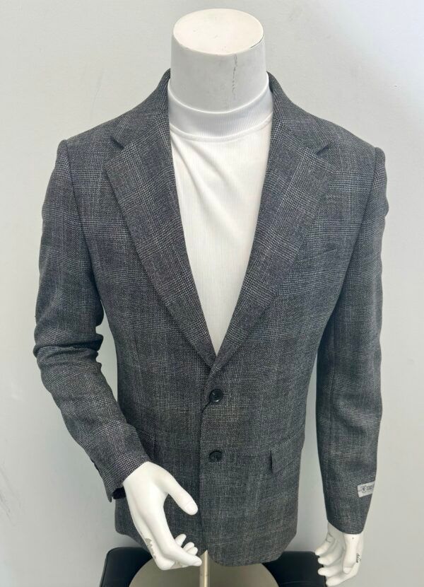 A mannequin is wearing a grey jacket and a white turtleneck.
