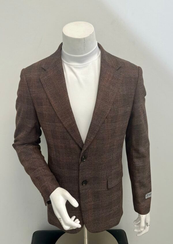 A mannequin wearing a brown jacket and a white turtleneck