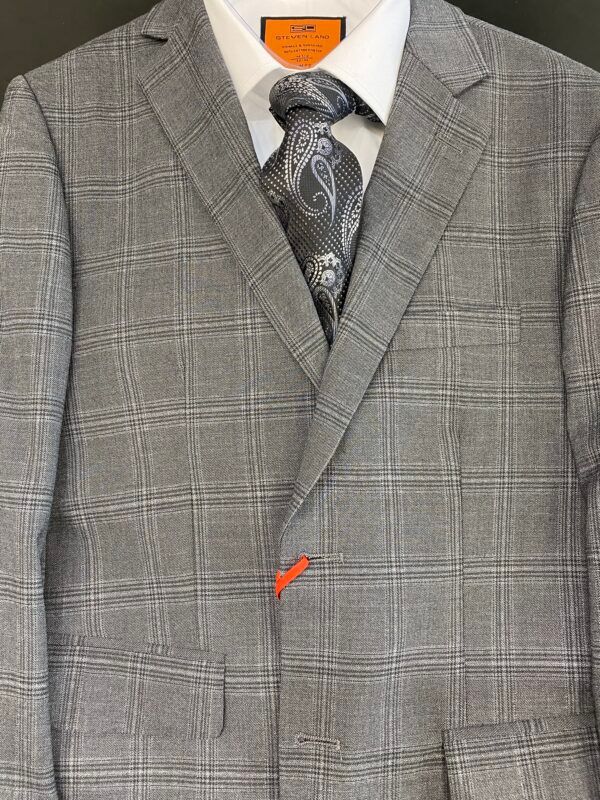 A close up of a suit jacket and tie with orange buttons