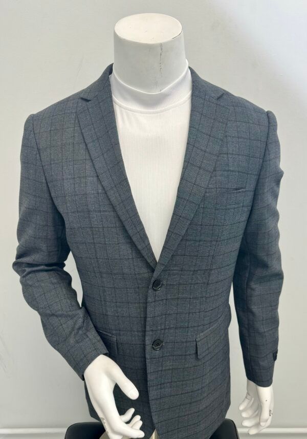 A mannequin wearing a grey plaid jacket and a white turtleneck