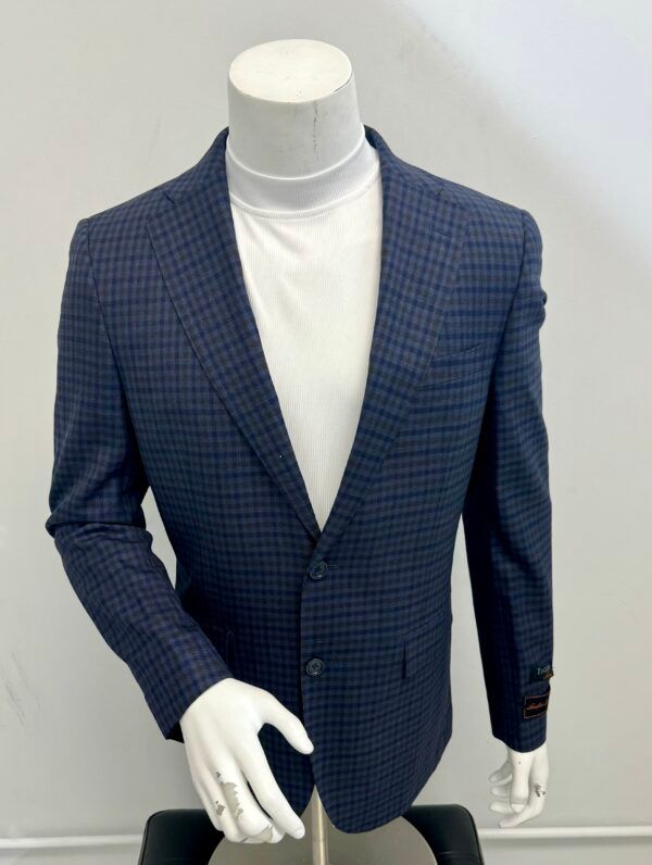 A mannequin wearing a blue plaid jacket and a white turtleneck