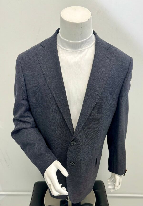 A mannequin wearing a suit jacket and a white turtleneck