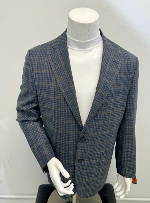 A mannequin is wearing a plaid jacket and a white turtleneck.
