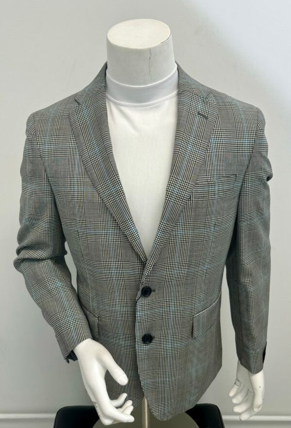 A mannequin is wearing a plaid jacket and a white turtleneck