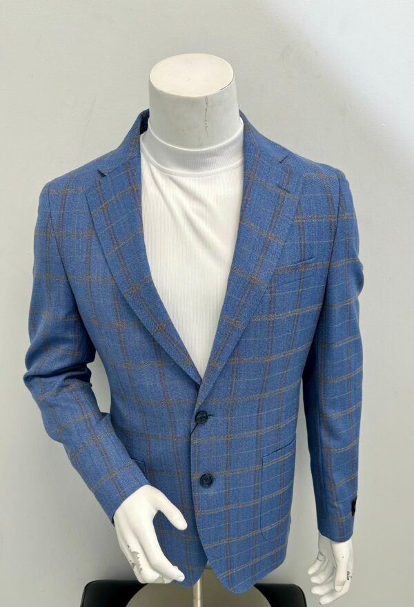 A mannequin is wearing a blue plaid jacket and a white turtleneck.