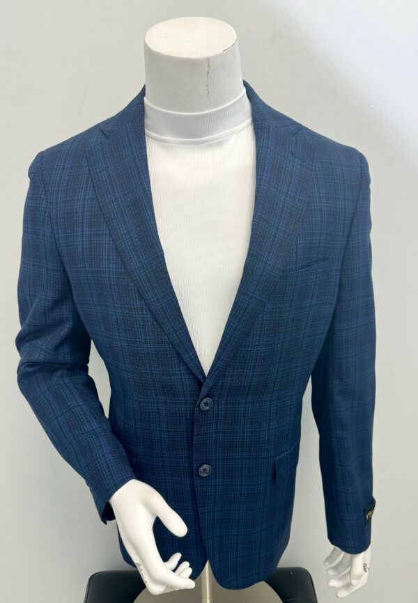 A mannequin wearing a blue jacket and white turtleneck