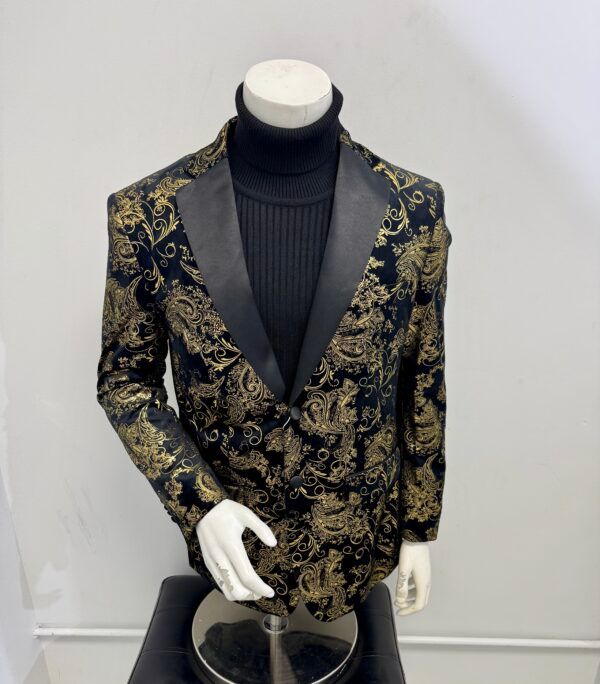 A black and gold jacket is on a mannequin