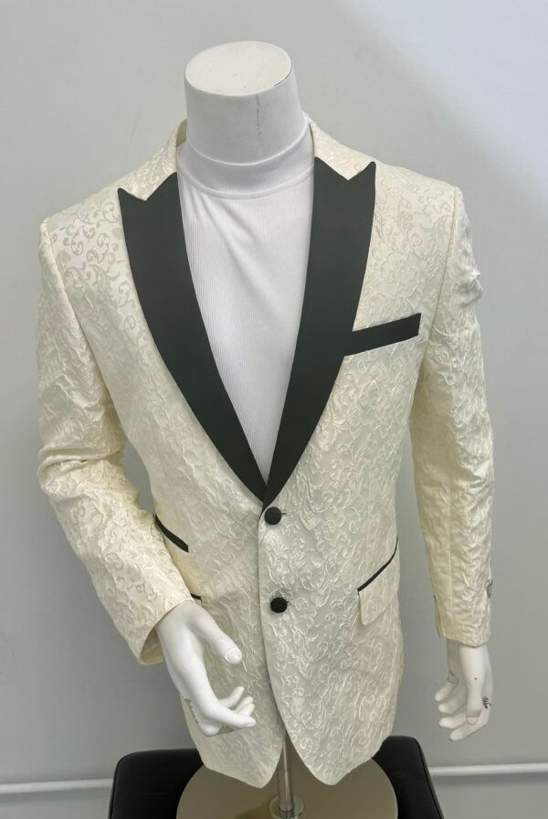 A white tuxedo jacket with a black lapel is on a mannequin.