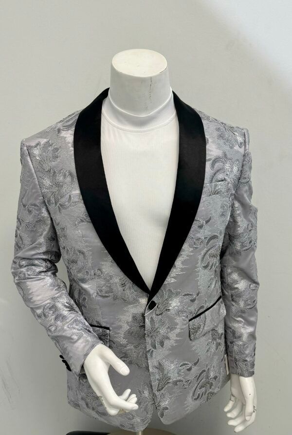 A mannequin is wearing a silver tuxedo jacket with a black collar.