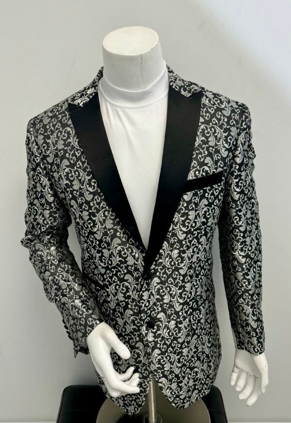 A black and white blazer is on a mannequin
