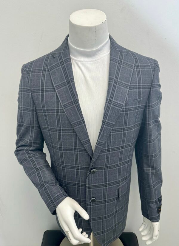 A mannequin wearing a grey plaid jacket and a white turtleneck