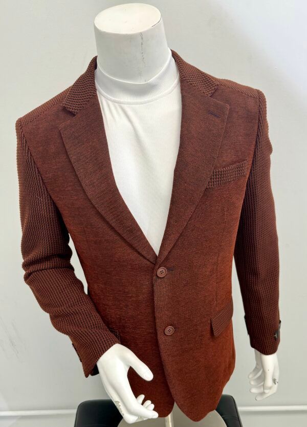 A mannequin is wearing a brown jacket and a white turtleneck
