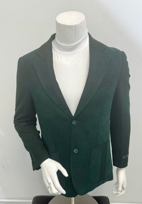 A mannequin wearing a green jacket and a white turtleneck