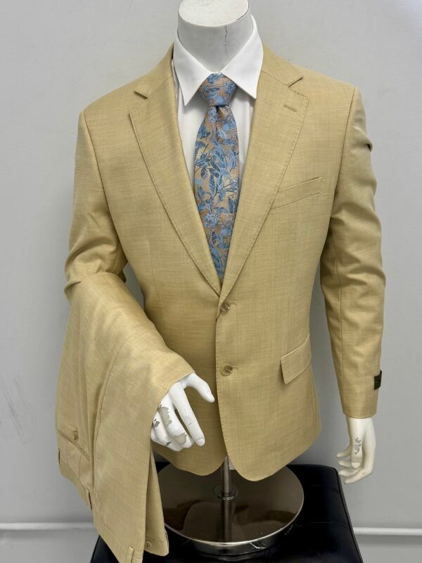 A mannequin is wearing a tan suit and tie