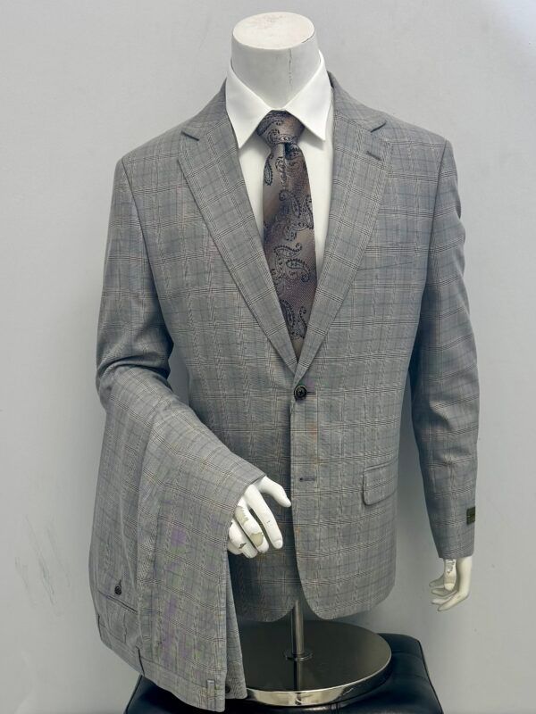 A mannequin is wearing a grey suit and tie