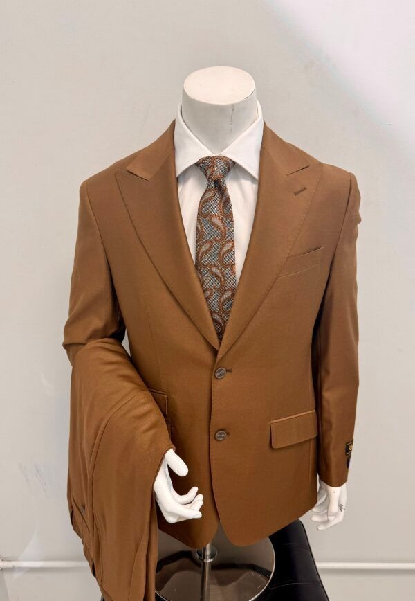 A mannequin is wearing a brown suit and tie.