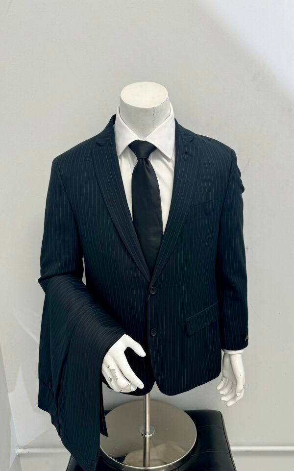 A mannequin is wearing a suit and tie.