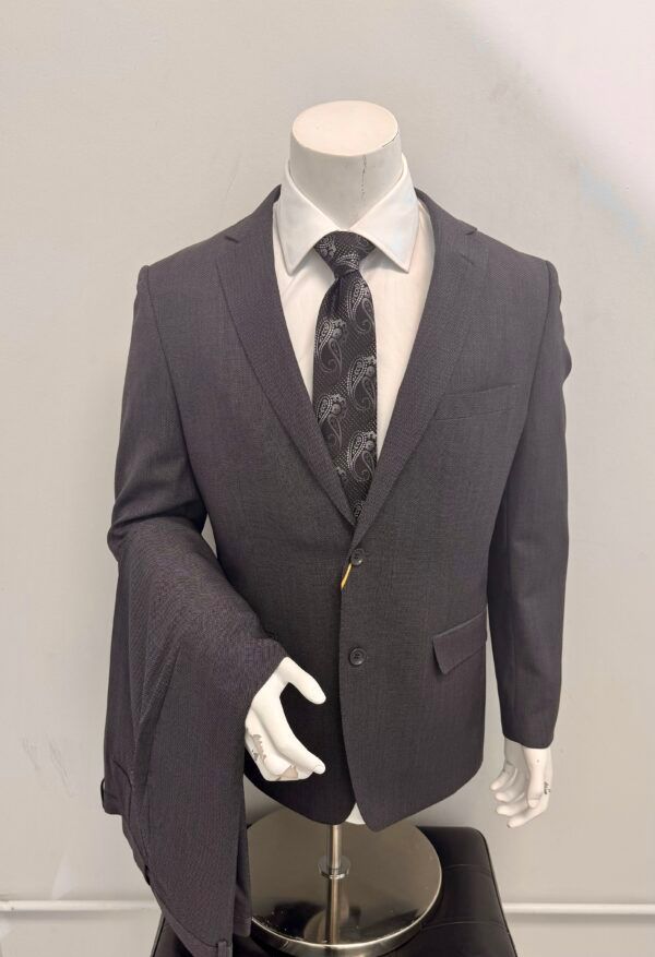 A mannequin is wearing a suit and tie.