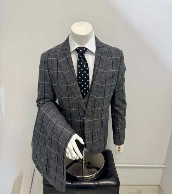 A mannequin is wearing a suit and tie.