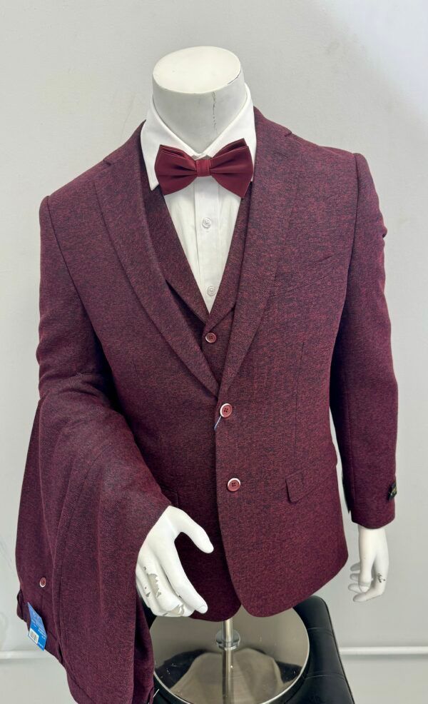 A mannequin is wearing a burgundy suit with a bow tie.