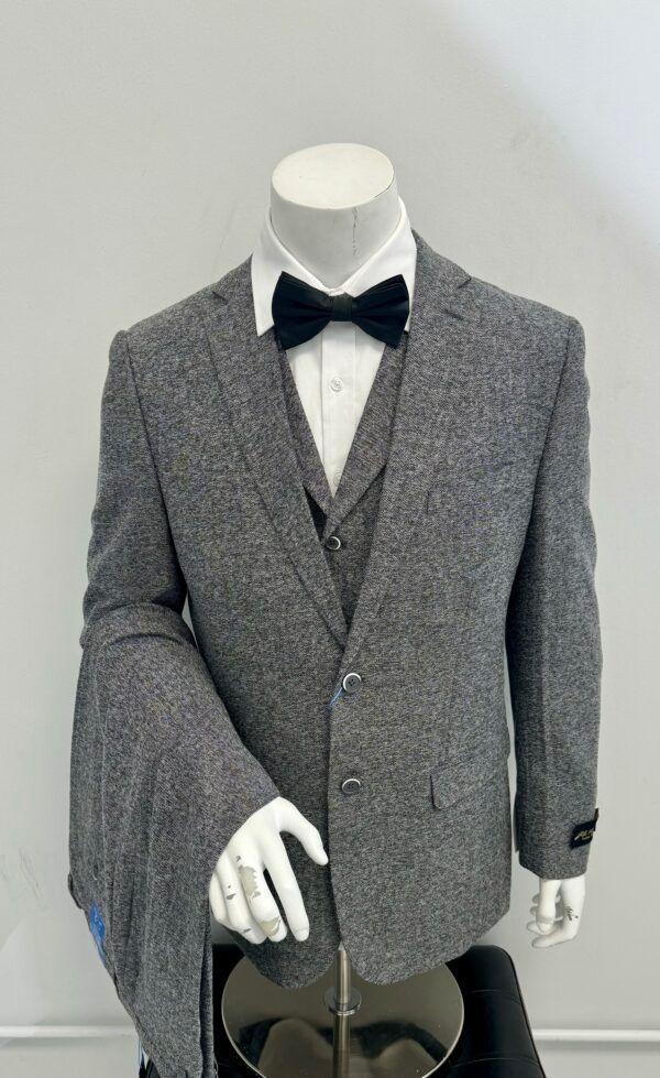 A mannequin is wearing a grey suit and bow tie.