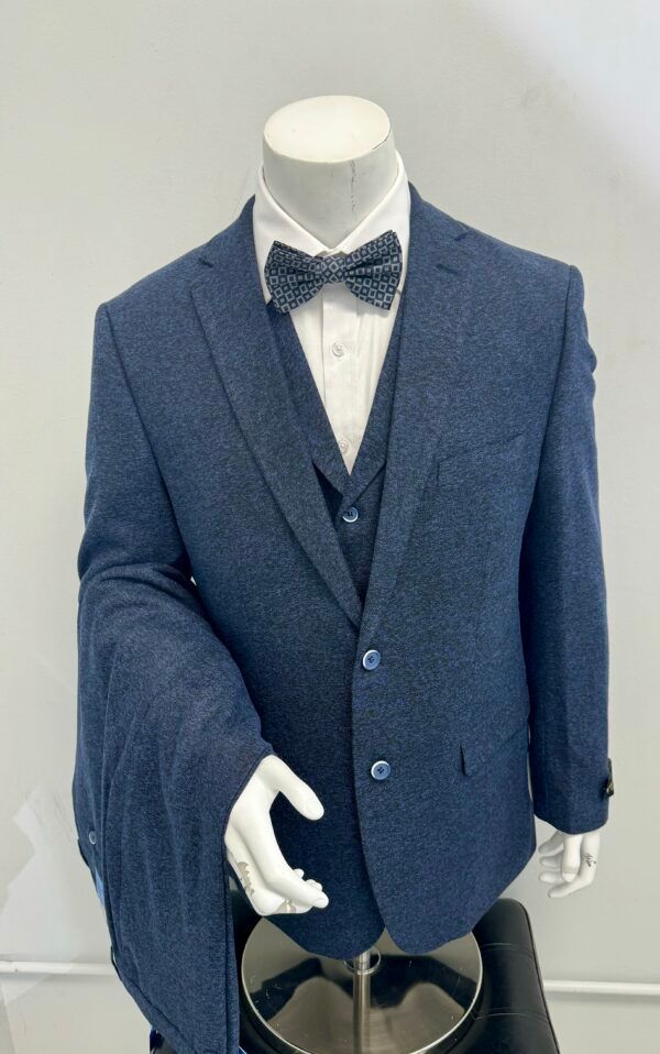 A mannequin is wearing a blue suit and bow tie.