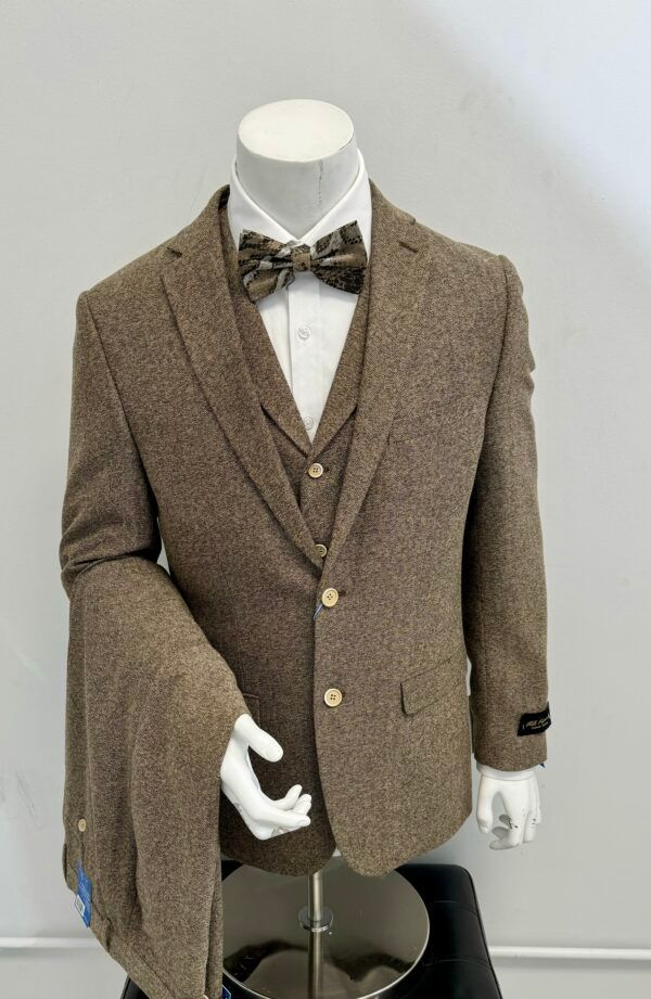 A mannequin is wearing a brown suit and bow tie.