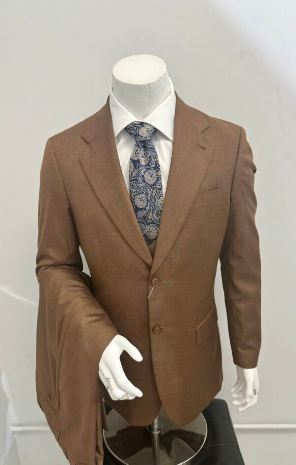 A mannequin is wearing a brown suit and tie.