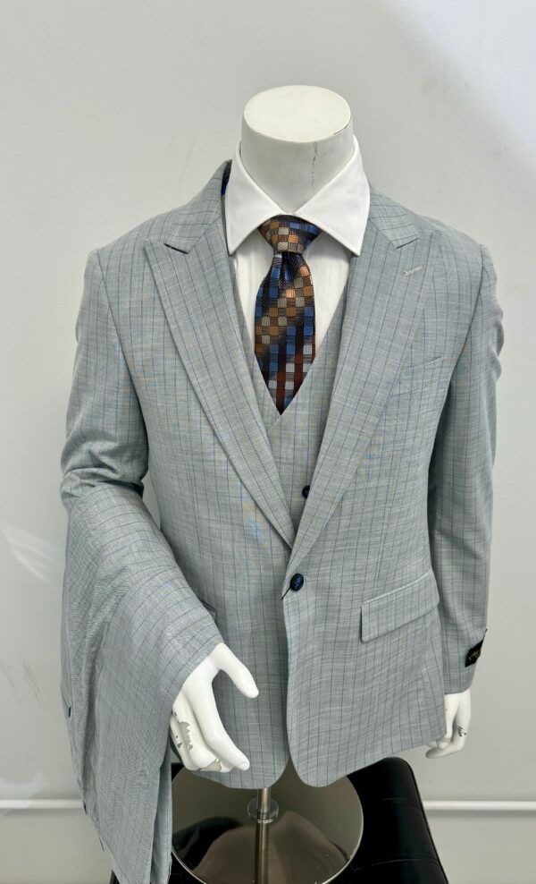 A man is wearing a suit and tie on a mannequin.