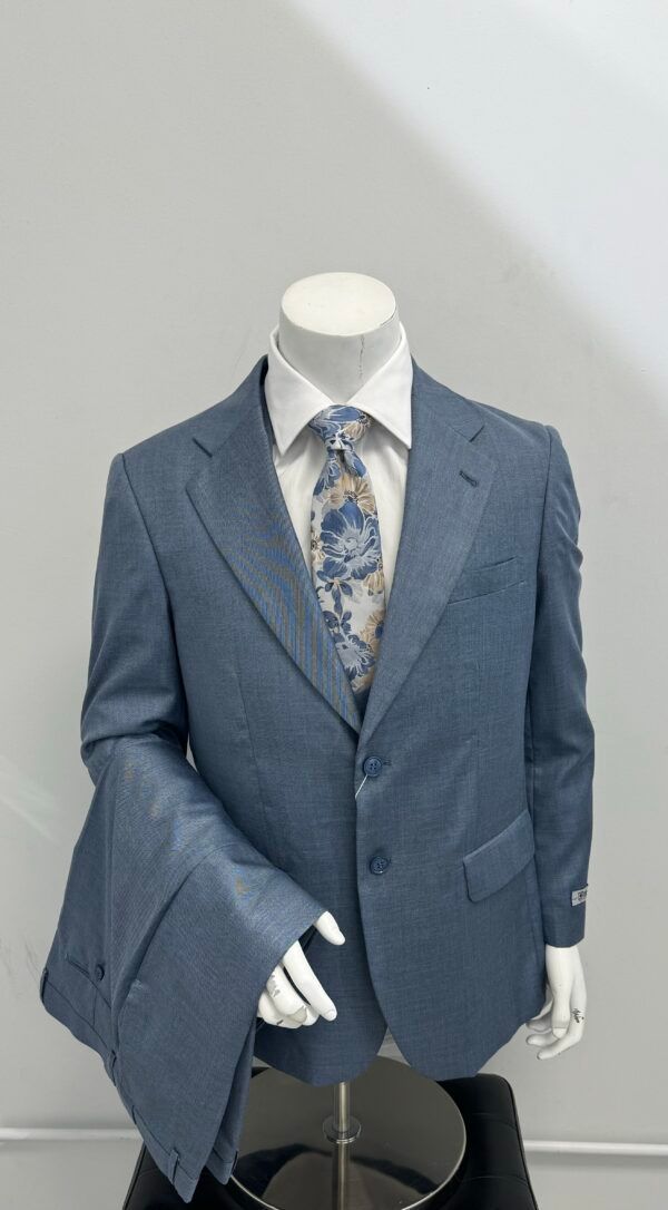A mannequin is wearing a blue suit and tie.