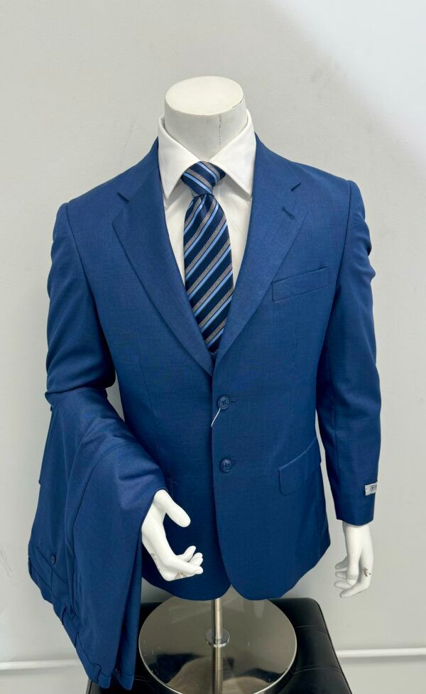 A mannequin is wearing a blue suit and tie.