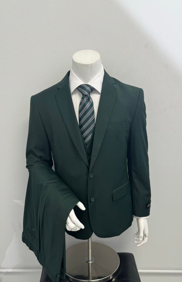 A mannequin is wearing a green suit and tie.