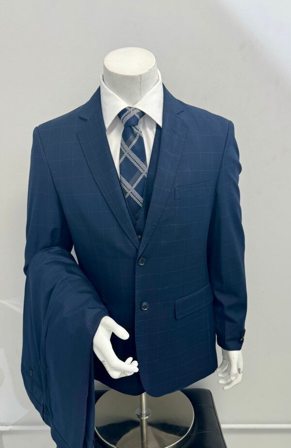 A mannequin is wearing a blue suit and tie.
