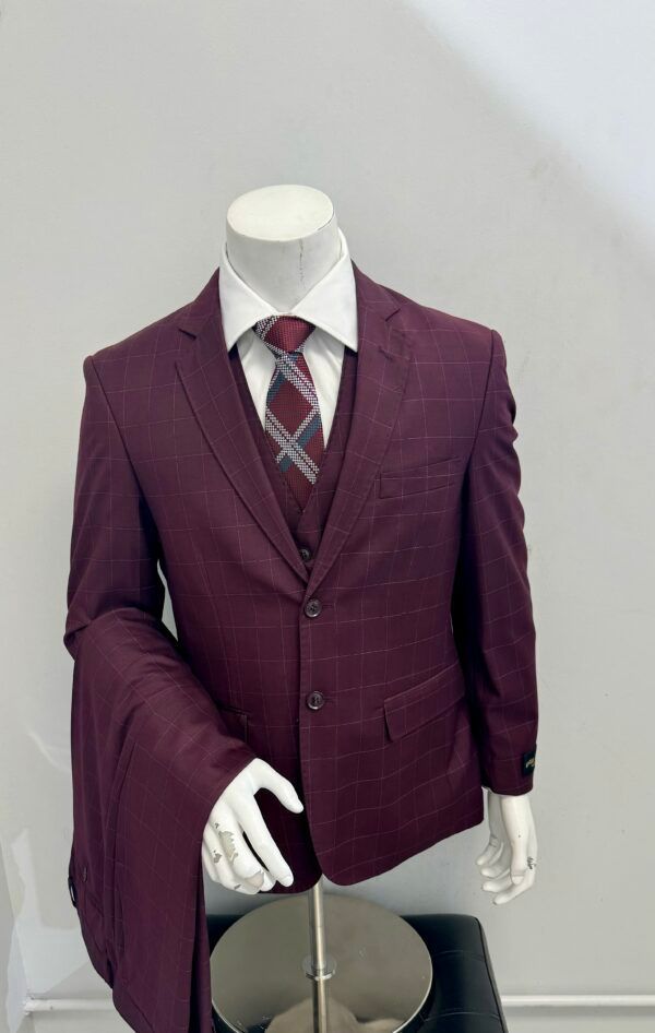 A mannequin is wearing a burgundy suit and tie.