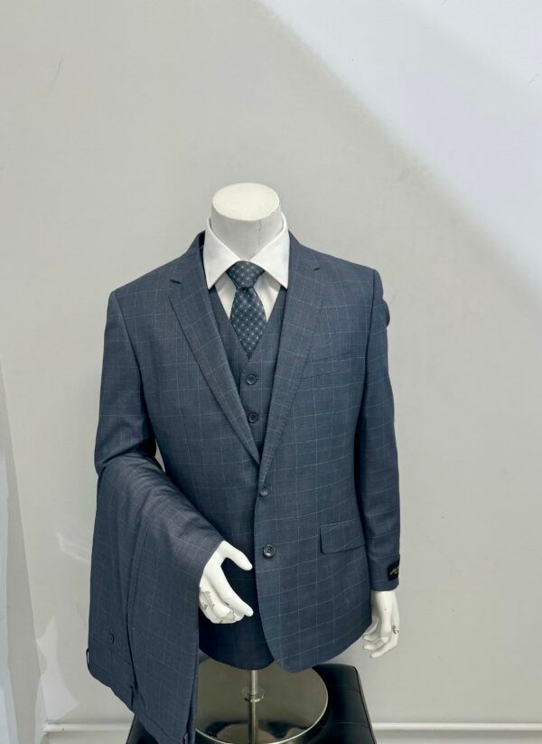 A mannequin is wearing a suit and tie.