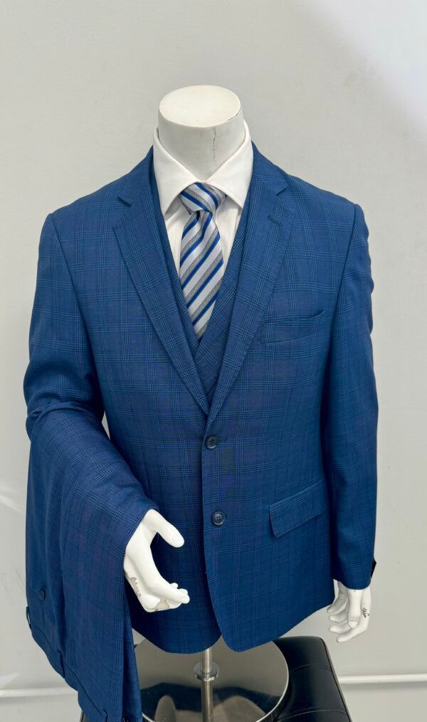 A mannequin is wearing a blue suit and tie.