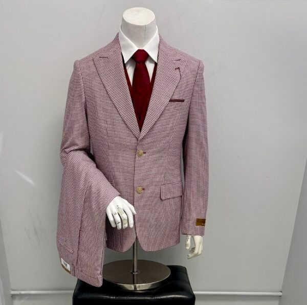 A mannequin wearing a pink suit and red tie
