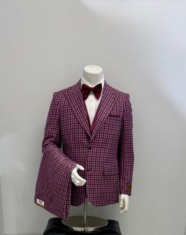 A mannequin is wearing a purple suit and bow tie.