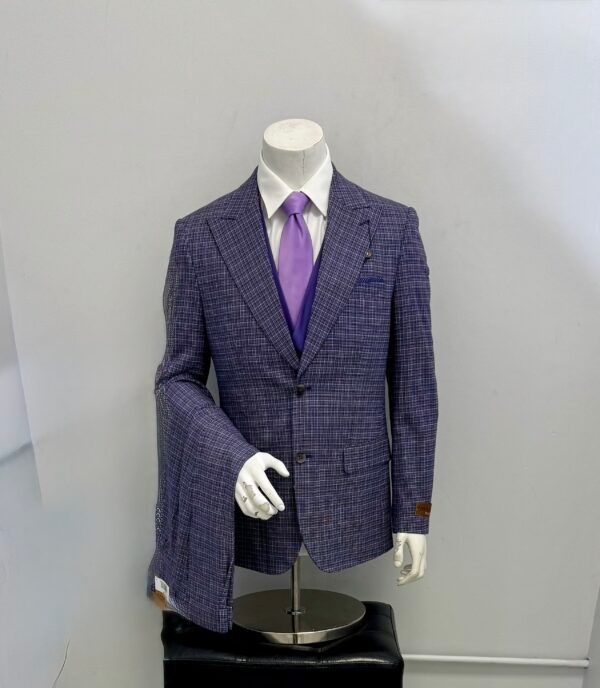 A mannequin is wearing a purple suit and purple tie.