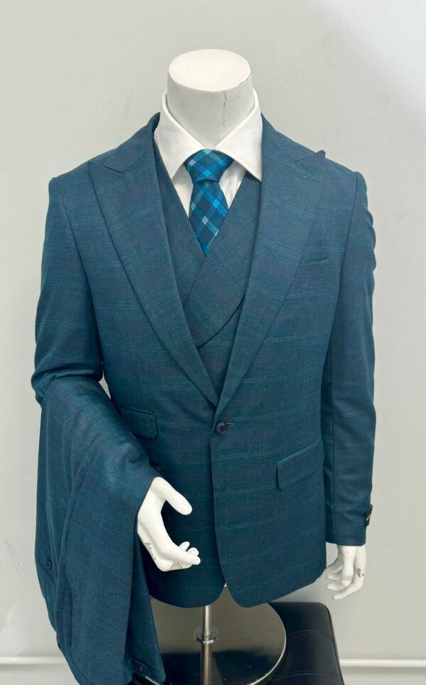 A mannequin is wearing a blue suit and tie.